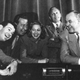 Jack Benny's cast, from left: Eddie Anderson, Dennis Day, Phil Harris, Mary Livingstone, Jack Benny, Don Wilson, Mel Blanc